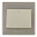 Philips flush-mount light switch plate in a brushed silver metal finish with a cream-colored central button panel.Supplied by Chinoy Electric