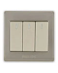 A three-button wall switch plate with a brushed silver frame and cream-colored rocker switches, featuring the PHILIPS brand name at the bottom.Supplied by Chinoy Electric