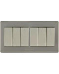 A six-light switch plate set in a brushed silver metal frame with six individual white toggle switches, shown against a plain white background.Supplied by Chinoy Electric