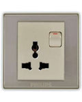 Philips three-pin UK wall socket with a single-pole switch, featuring a brushed silver metal frame and a cream-colored center panel.Supplied by Chinoy Electric